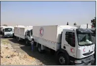  ?? AP ?? A convoy of vehicles from the Syrian Red Crescent arrives Monday in the eastern Ghouta area near Damascus, Syria, in this photo released by the aid group. The Monday mission was cut short because of government shelling.