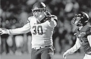  ?? [PHOTOS BY ALONZO ADAMS, FOR THE OKLAHOMAN] ?? Putnam City North tight end Will Taylor celebrates after a touchdown catch Thursday night at Norman North.Norman North’s Cole Mashburn, left, brings down Putnam City North’s Tyce Mythen during Thursday night’s high school game at Harve Collins Field in Norman.