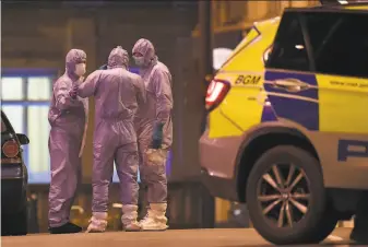  ?? Alberto Pezzali / Associated Press ?? Forensic officers confer near the scene of the stabbing attack in the Streatham neighborho­od, about 5 miles south of central London. The attacker had been under surveillan­ce.