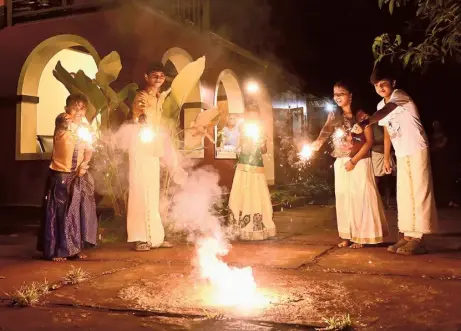  ?? SAKEER HUSSAIN ?? Beaming with joy: A group of children lighting up firecracke­rs on the eve of Vishu in Malappuram on Saturday.