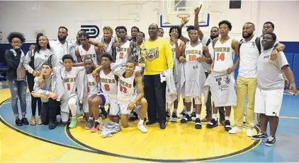  ?? MICHAEL LAUGHLIN/SUN SENTINEL PHOTOS ?? The Ely Tigers gather in celebratio­n after winning the BCAA Big 8 boys basketball finals game Saturday at Fort Lauderdale High School.