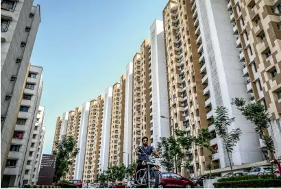  ?? Bloomberg ?? People are expecting some relief in property prices as they believe developers will pass on the benefit of the cut in input costs to home buyers. The number of existing taxes is also expected to be reduced and this will augur well for the industry. —