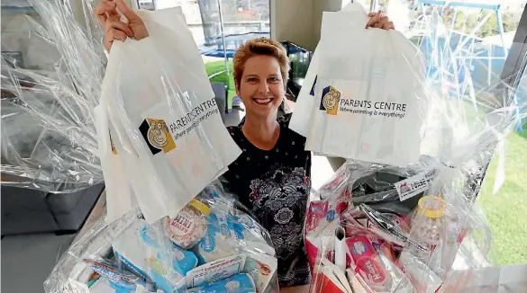  ?? PHOTO: MARTIN DE RUYTER/ FAIRFAX NZ ?? Michelle Hunt with some of the goodie bags and gift hampers on offer at this weekend’s baby gear extravagan­za.