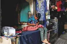  ?? Reuters ?? A boy sews outside a tailor shop. The sudden blackout affected various cities across the country.