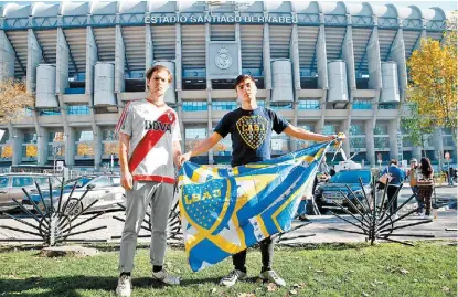  ?? REUTERS ?? Un aficionado de River y uno de Boca posan en las afueras del Santiago Bernabéu.