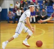  ?? JOHN BREWER - ONEIDA DAILY DISPATCH ?? Madison’s Spencer Haviland takes McGraw’s Maurice Peterson off the dribble during Tuesday’s Central Counties League matchup.