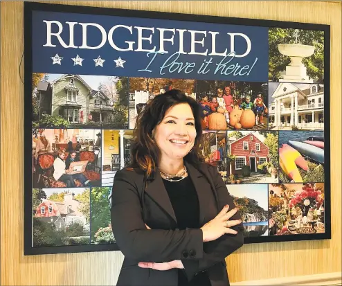  ?? Chris Bosak / Hearst Connecticu­t Media ?? Kim Bova, new executive director of the Ridgefield Chamber of Commerce, stands in the organizati­on’s office in Ridgefield on Thursday.