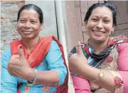  ?? AFP ?? Nepalis hold up their thumbs, marked with indelible ink to show they have voted, outside a polling station in Thimi, outside Kathmandu yesterday.