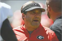  ?? The Associated Press ?? POOR TIMING: Georgia coach Kirby Smart looks on during warm ups on for an Aug. 17, 2019, NCAA football preseason scrimmage in Athens, Ga. Smart says quarterbac­k is the position most affected by spring practice being canceled by the coronaviru­s pandemic. It’s bad timing for the Bulldogs, who would have used the spring as a time to have Wake Forest transfer Jamie Newman and others compete to replace three-year starter Jake Fromm.