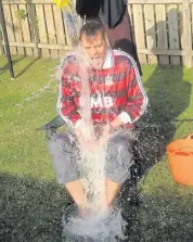  ??  ?? Wet, wet, wet Tom Greatrex MP is soaked during the ice bucket challenge