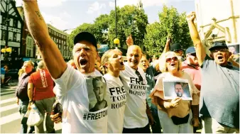  ??  ?? Former EDL leader Tommy Robinson’s supporters outside the High Court in London on Wednesday