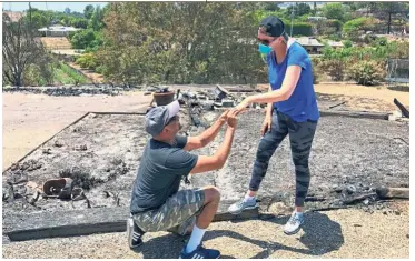  ?? — AP ?? Starting anew: Ishu proposing to Laura with her damaged wedding ring at their destroyed home in Goleta, California.