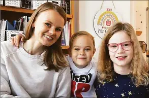  ?? Ned Gerard / Hearst Connecticu­t Media ?? Olena Ustinov and her son, Lev, and daughter, Neva, pose during an interview at King’s Highway Elementary School, in Westport. The Ustinov family is currently living in Westport after fleeing Ukraine earlier this year.