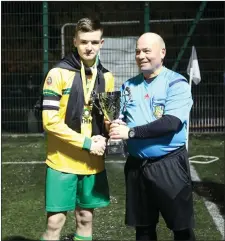  ??  ?? Rathnew rising star William Moorehouse collects the U15 Premier Jako Cup after he guided the Village team to victory over Coolboy recently. In last week’s edition the caption on the above photo incorrectl­y stated that Ethan Snell was the captain but it was William who led the way and who also made three assists during what was a superb final. It’s been a busy time for the talented William with this crown following hot on the heels of the county Minor ‘A’ football title he won with Rathnew when he scored a point from play in a superb performanc­e from midfield.