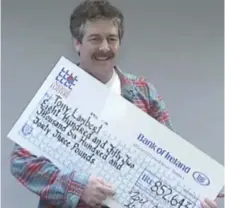  ??  ?? Former Saw Doctors member Tony Lambert with his cheque when he won more than £800,000 in the Lotto in 1993