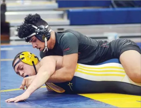  ?? GREGG SLABODA — TRENTONIAN PHOTO ?? Trenton’s Manny Reyes (top) ties up Nottingham’s Josh Almanzar at 170 lbs.