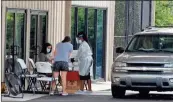  ?? Doug Walker ?? Medical personnel prepare to take a COVID-19 test at the West Rome Baptist location Thursday afternoon.