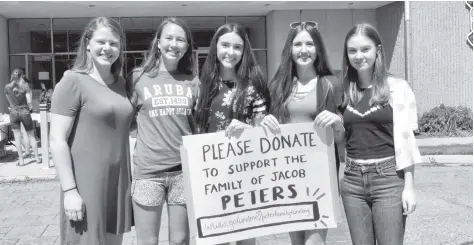  ?? [VERONICA REINER / THE OBSERVER] ?? The student-run effort to raise money for the Peters family included a barbecue fundraiser and bake sale at EDSS on Tuesday. EDSS Grade 12 students are promoting a GoFundMe page for the family of one of their classmates.