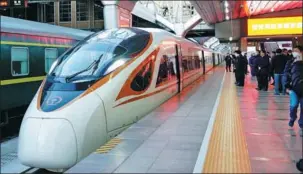  ?? ZHANG CHENLIN / XINHUA ?? Passengers wait to board a high-speed train on the Beijing-Tangshan intercity railway in Beijing on Dec 30.