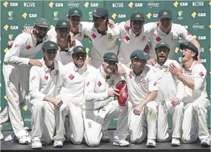  ??  ?? SYDNEY: The Australian team pose for a photo with their trophy after defeating Pakistan in their cricket Test match in Sydney, Australia, yesterday. —AP