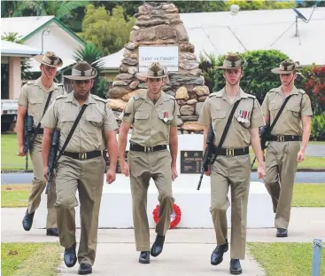  ?? Pictures: JUSTIN BRIERTY ?? MARCHING FORWARD: The 51st Battalion’s Kitione Waigana, Matt Miller, Guard Command Luke Skennerton, Chris Sterling and Anthony Lynn mark 80 years of the regiment calling Far North Queensland home at a wreath-laying ceremony at Fuller Park, Edmonton.