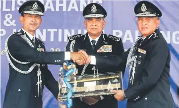  ??  ?? Khalid (centre) witnessing the handing over of duties from Sharifuddi­n (left) to Rosli. — Bernama photo