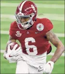  ?? Roger Steinman / Associated Press ?? Smith is the fourth receiver to win the Heisman. Quarterbac­ks had won 17 of the previous 20 Heisman trophies.