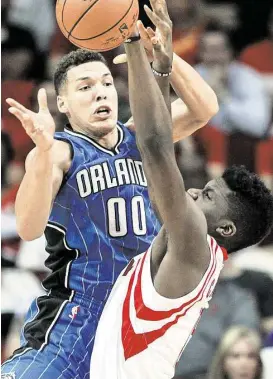  ?? Brett Coomer / Houston Chronicle ?? Clint Capela, right, battles Orlando’s Aaron Gordon for the ball during the Rockets’ overtime victory at Toyota Center on Wednesday. In his second NBA season, Capela is averaging 7.6 points, 5.2 rebounds and 1.6 blocks per game.