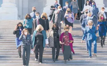  ?? J. SCOTT APPLEWHITE/AP ?? House Speaker Nancy Pelosi, D-Calif., second left, and members of the Democratic Caucus walk down stairs Wednesday outside the U.S. Capitol to address reporters.