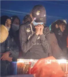  ?? EDDIE MOORE/JOURNAL ?? Bianca Vega attends a candleligh­t vigil for her son, Santa Fe High basketball star Fedonta “J.B.” White, who was shot to death during a late-night party last weekend. Around 200 people attended the memorial Monday.