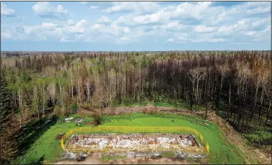  ?? (AP/Noah Berger) ?? Yellow fencing surrounds on July 3 a fourplex destroyed by a May wildfire at Sturgeon Lake Cree First Nation, northwest of Edmonton, Alberta. The building housed four of the tribe’s elders.