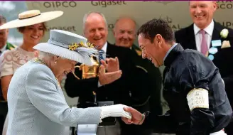  ?? PA ?? All smiles: the Queen greets Dettori after his Gold Cup victory last year