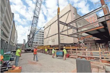  ?? MIKE DE SISTI / MILWAUKEE JOURNAL SENTINEL ?? Workers are preparing for this month's move of the back wall of the former Warner Grand Theatre in downtown Milwaukee. The 625-ton wall will be moved 35 feet east as part of the building's conversion into the new Milwaukee Symphony Orchestra concert hall.