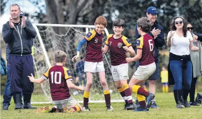  ?? PHOTOS: PETER MCINTOSH ?? The feeling of victory . . . Maori Hill Country players (from left) Marley McLean, Finn Curtis, Eli desFountai­n and Robert Lloyd (all 10) celebrate a win against a Queenstown team during the Green Island Junior Football Club sevenaside tournament yesterday.