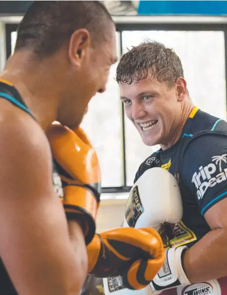  ?? Picture: GOLD COAST TITANS ?? Jarrod Wallace (right) takes the fight to Leilani Latutake at Titans training.