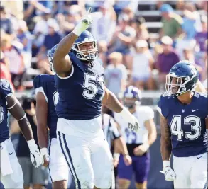  ?? UConn Athletics / Contribute­d Photo ?? UConn defensive tackle Travis Jones (57) celebrates a play against Holy Cross on Sept. 4 in East Hartford.