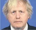  ??  ?? SOLEMN Boris Johnson yesterday