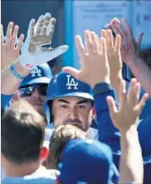  ?? Robert Gauthier Los Angeles Times ?? ADRIAN GONZALEZ is congratula­ted by Dodger teammates after his two-run homer on Tuesday.