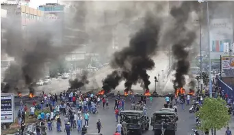  ?? AFP ?? Demonstrat­ors burn tyres during a protest against government corruption and dire economic conditions in the industrial zone of Dora, on the outskirts of Beirut, yesterday.