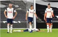  ??  ?? LAID OUT Dejected Spurs can’t believe they’ve blown lead