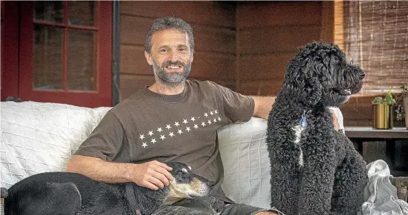  ?? WARWICK SMITH/STUFF ?? Infectious disease expert David Hayman, with dogs Harvey, left, and Rocco, is the Manawatu¯ Standard person of the year for 2020.