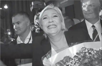  ?? THE ASSOCIATED PRESS ?? Far-right leader and French presidenti­al candidate Marine Le Pen, surrounded by bodyguards, celebrates with supporters after the first round of voting.