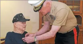  ?? GENE WALSH — DIGITAL FIRST MEDIA ?? Lt. General Richard P. Mills fastens a pin onto World War II veteran Louis Rittelmann during ceremony at Phoenixvil­le Care and Rehab Center.