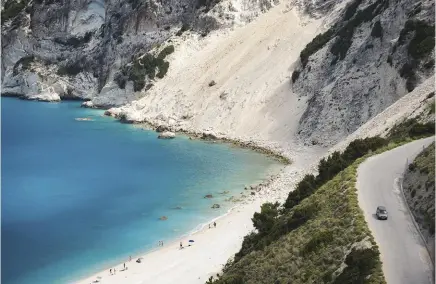  ??  ?? The aquamarine waters, dramatic limestone cliffs and white beach at Myrtos Bay