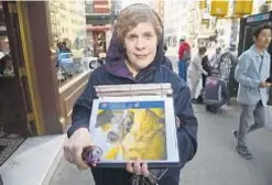  ?? ?? Elizabeth Grant holds photos of some of the many animals that filled her Queens home.