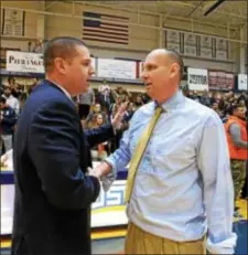  ?? DFM TIMES ?? In a more cordial postgame ritual two years ago, Neumann coach Jim Rullo, right, and Cabrini’s Tim McDonald shake hands. Monday’s renewal of the CSAC rivalry — a 92-83 win for the Knights — ended with a brief postgame scuffle between the teams instead.