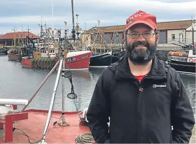  ??  ?? Round Britain walker Kieran Sandwell during a stop-off at Arbroath harbour yesterday.