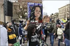  ?? AP PHOTO/TIMOTHY D EASLEY ?? A protester holds up a painting of Breonna Taylor during a rally on the one year anniversar­y of her death at Jefferson Square Park in Louisville, Ky., Saturday.