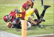  ??  ?? AJENE HARRIS (27) and Iman Marshall stop Utah’s Troy Williams on a two-point conversion try.