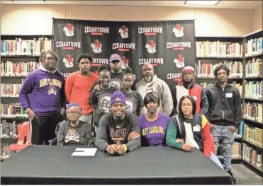  ??  ?? Taji Hudson was joined his family and friends at Cedartown High for his official signing with East Carolina on Dec. 18.